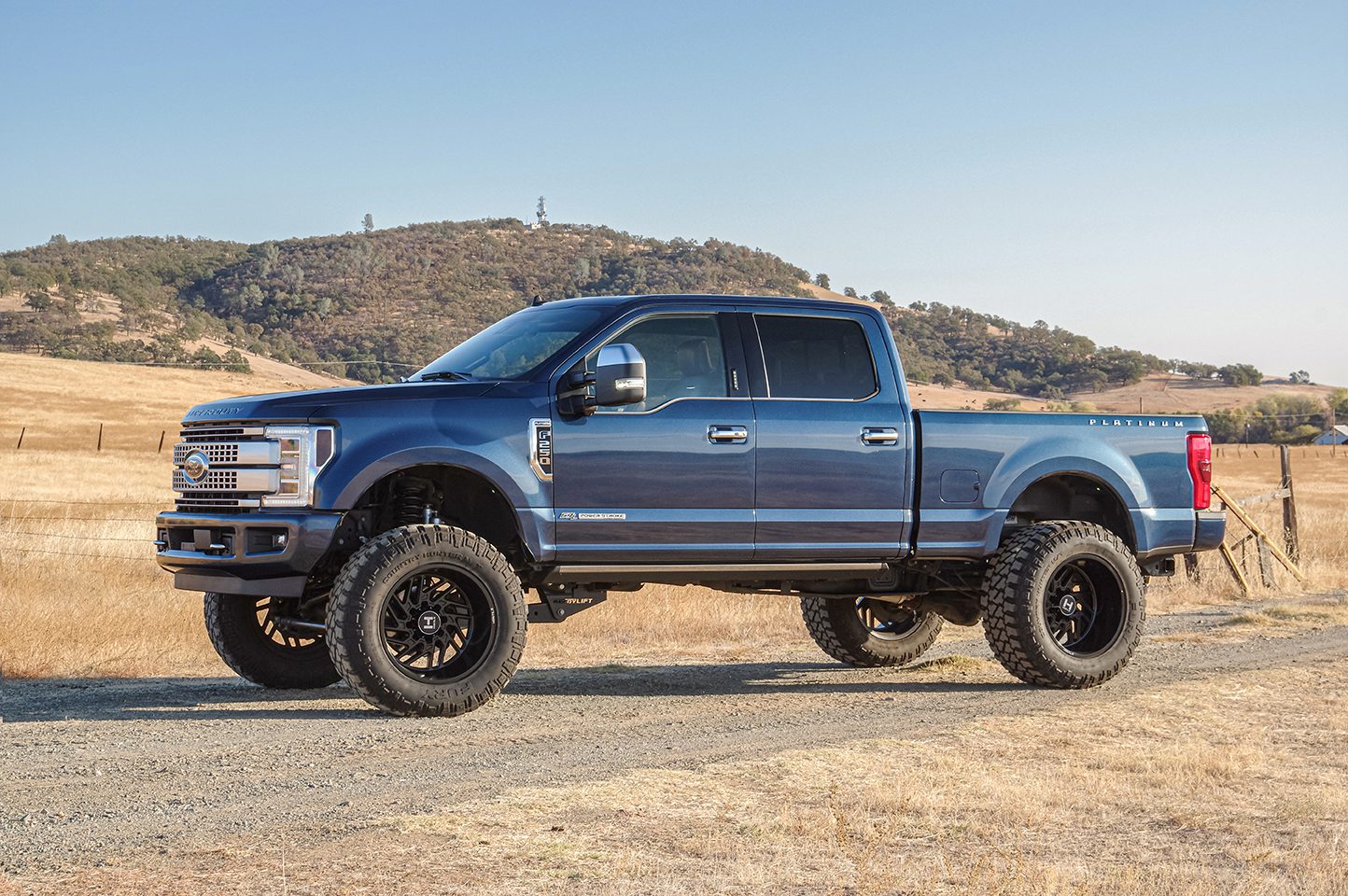 Blue Ford F-250 truck outfitted with rugged tires