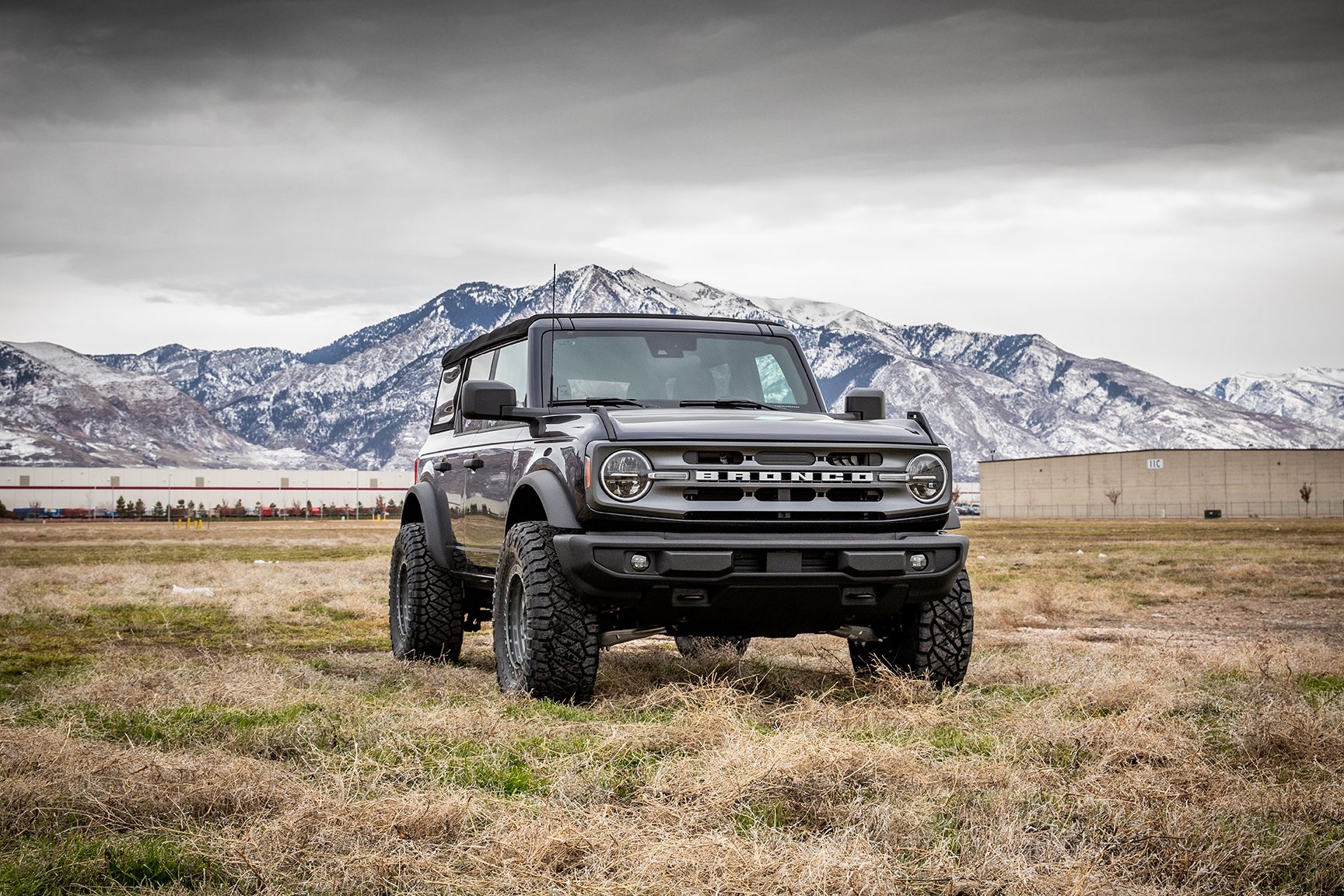 Ford Bronco parked outside a Burt Brothers location, showcasing rugged design and off-road readiness as part of premium service package.