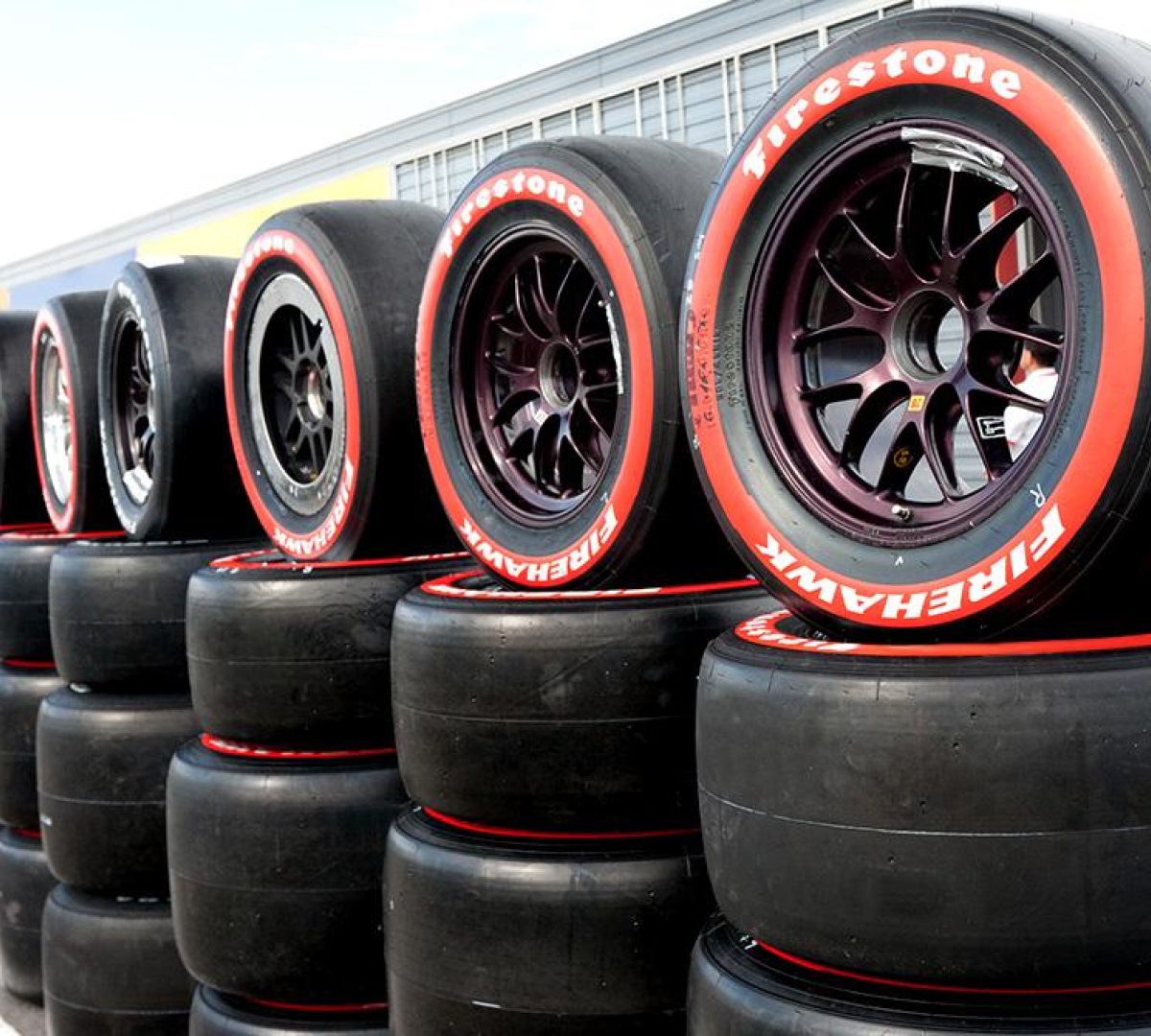 Firestone Firehawk racing tire with a distinctive red sidewall.