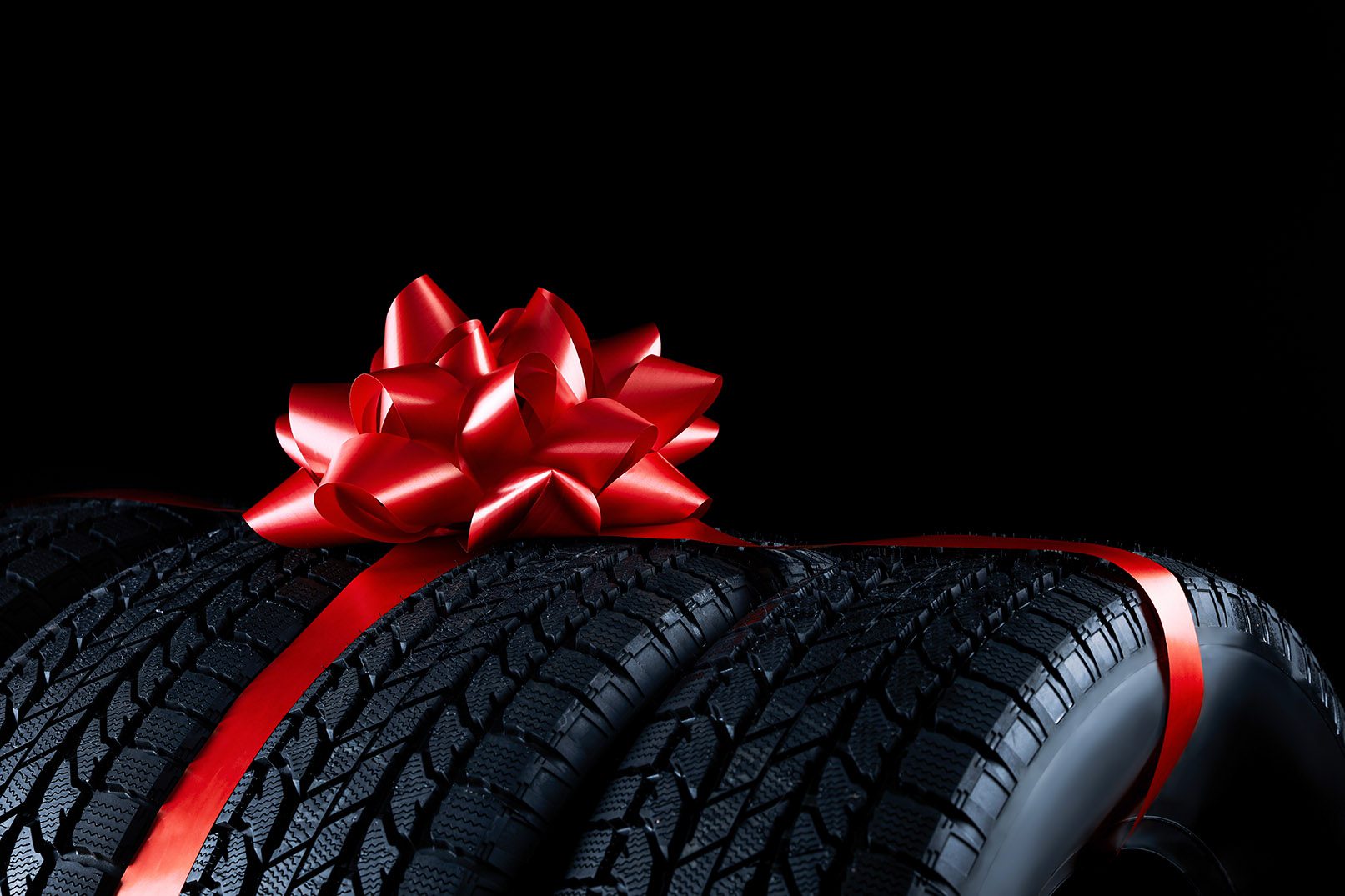 Image of four new wrapped tires, part of The Burt Bundle package.