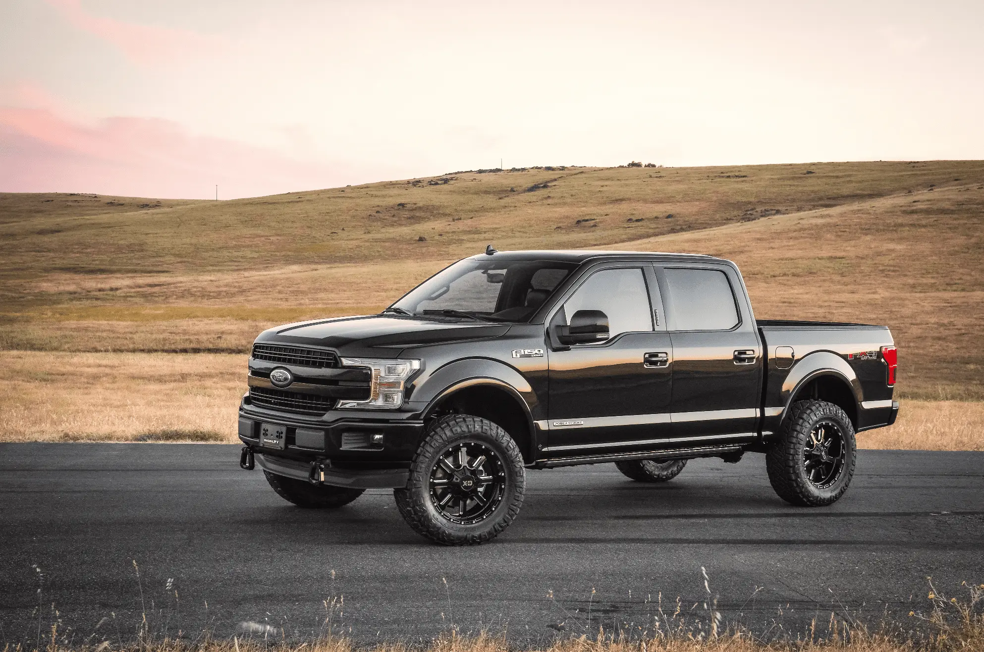 Image of a black lifted Ford F-150 pickup truck.